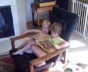 Ronan has started wanting to read to his little brother, and is very insistant that Eamon come up to read.Here Eamon has crawled up on the chair next to Ronan, and Ronan is