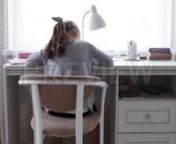 Get 100&#39;s of FREE Video Templates, Music, Footage and More at Motion Array: http://bit.ly/2SITwWM nnnGet this here: https://motionarray.com/stock-video/girl-doing-homework-177795nnThe Girl Doing Homework stock video is an incredible bit of video that displays a back view shot of a young Caucasian school girl doing homework at home. This 1920x1080 (HD) footage is perfect to use in any project that depicts education, studying, children, school, etc. This clip will look great in your next movie, so