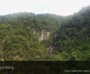Drone aerial footage view flying over waterfall cliff in the middle of the forest tress jungle - eastern cape Transkei and wild coast.nnThis stock video is available for licensing from major stock video agencies. For best rates, purchase and download a full resolution version without a watermark directly from Africa Rising here: https://www.africarising.tv/downloads/african-stock-video-drone-footage-waterfall-in-forest-wild-coast-transkei-south-africa/