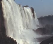 Archival footage shot by an amateur filmmaker while touring Brazil in 1981 nnIt contains stock footage of Iguazu Falls, waterfalls on the border with Argentina: panoramas of the waterfalls and the jungle, visitors walking on piers that cross the Iguazu River, and more.nnPlease, comment if you recognize more subjects.nnIf you want to buy this footage to use it in your production, please visit: nhttps://footageforpro.com/iguazu-falls-1981-archive-footage/nnIf you want to buy segments of this foota