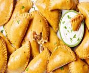 Upgrade your dinner (or appetizer) game with this easy recipe for classic beef empanadas, paired with cilantro and sour cream for dipping.