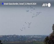 Parachutes with humanitarian aid fall from the sky following an airdrop in northern Gaza, seen from Israel. &#60;br/&#62;Gaza&#39;s deadliest war showed no signs of abating as the Muslim holy month of Ramadan begins amid a gruelling humanitarian crisis that has pushed much of the territory to the brink of starvation.