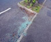 Debris and broken glass can been seen on the road from a crash on Warley Road in Smethwick which saw a car crash into the back of a minibus on Saturday night around 11pm